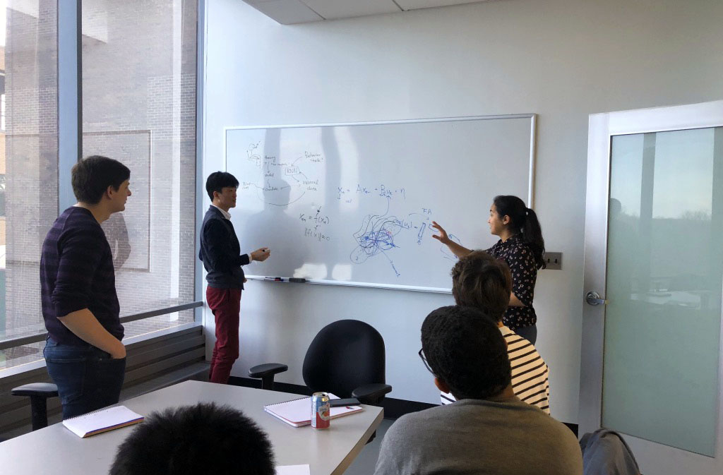 CATNIP lab gathered around a whiteboard